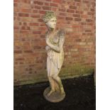 A LARGER STONE GARDEN FIGURE, in the form of a Grecian style figure in robe, H 160 cm