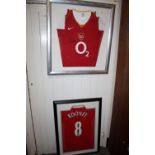 A FRAMED AND GLAZED SIGNED MANCHESTER UNITED WAYNE ROONEY FOOTBALL SHIRT, TOGETHER WITH AN ARSENAL