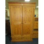 A LARGE PINE TWO DOOR WARDROBE WITH DRAWERS BELOW H-198 W-122 CM