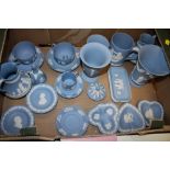 A TRAY OF BLUE WEDGWOOD JASPERWARE TO INCLUDE A TRUMPET VASE, CUPS AND SAUCERS ETC.