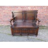 A VINTAGE OAK MONKS BENCH, with linen fold front, W 119 cm