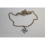 A SWASTIKA PENDANT ON STERLING SILVER CHAIN