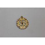 A YELLOW METAL SWASTIKA PENDANT STAMPED 22C APPROX WEIGHT - 4.8G