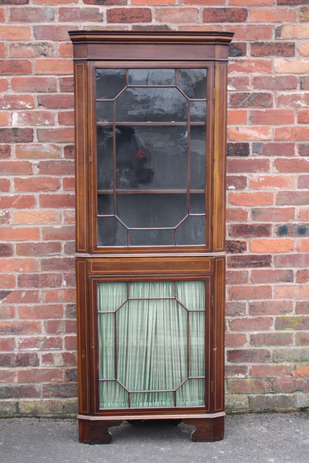 AN ANTIQUE MAHOGANY AND INLAID FLOOR STANDING CORNER CABINET, having two astragel glazed doors, H