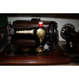 A MAHOGANY CASED JONES SEWING MACHINE TOGETHER WITH AN UNCASED SINGER EXAMPLE