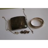 A QUANTITY OF HALLMARKED SILVER, to include a cigarette case, bangle, brooch and two chains with