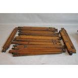 A TRAY OF VINTAGE OAK TRIPODS, approx. twenty five to include Ensign examples A/F