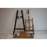 A SMALL ADJUSTABLE WOODEN ARTIST'S EASEL, H 85 cm, together with another slightly larger easel and a