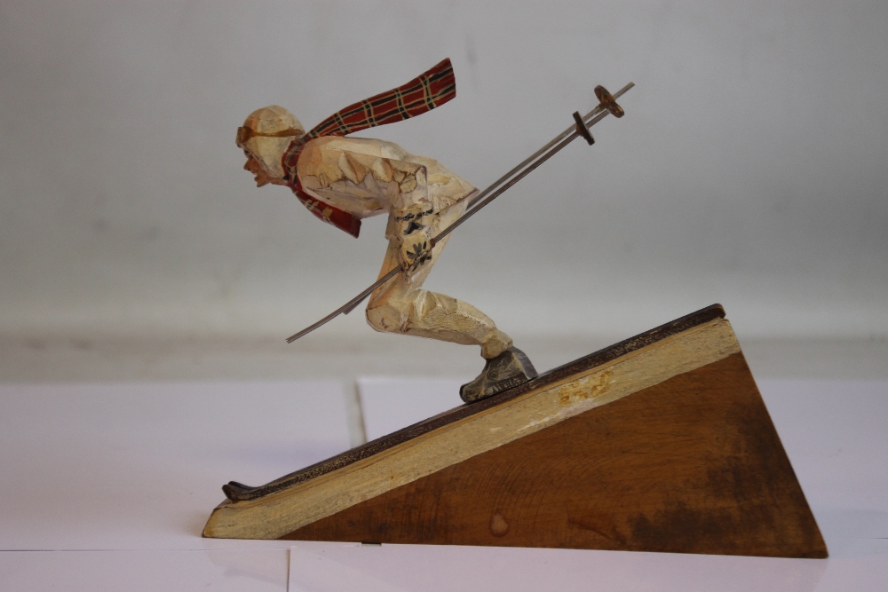 A BLACK FOREST CARVED AND PAINTED WOOD FIGURE OF A SKIER