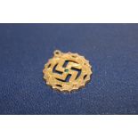 A YELLOW METAL SWASTIKA PENDANT STAMPED 22C