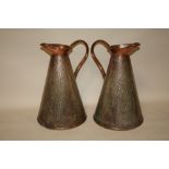A PAIR OF ARTS AND CRAFTS STYLE HAMMERED FINISH COPPER JUGS, H 37 CM