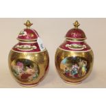 A PAIR OF ROYAL VIENNA GILDED PORCELAIN LIDDED VASES, each with blue beehive mark and titled in