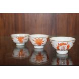 THREE SMALL CHINESE/ORIENTAL TEA BOWLS WITH ORANGE BACK STAMPS