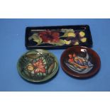 THREE MOORCROFT DISHES COMPRISING TWO PIN DISHES AND A RECTANGULAR TRAY