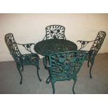 A CAST ALUMINIUM PATIO / GARDEN TABLE AND FOUR CHAIR SET A/F - ONE ARM MISSING AND DAMAGE TO TABLE