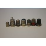 SEVEN SILVER AND WHITE METAL THIMBLES