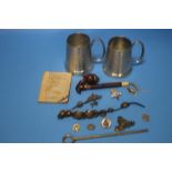 TWO WHITE METAL TANKARDS AND A COLLECTION OF MILITARY TYPE BUTTONS AND BADGES ETC.