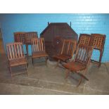 A FOLDING WOODEN GARDEN TABLE AND EIGHT CHAIRS SET