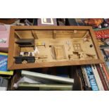 A SMALL BOX OF COOKERY BOOKS AND A FRAMED WOODEN KITCHEN SCENE