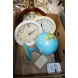 A BOX CONTAINING THREE CLOCKS, GLOBE OF THE WORLD, TWO CARBON MONOXIDE MONITORS AND A CAMERA