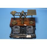 A SET OF POSTAL SCALES TOGETHER WITH A CAST INKWELL SET