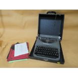 A CASED VINTAGE REMMINGTON RAND TYPE WRITER