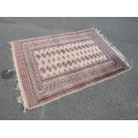 A VINTAGE EASTERN WOOLLEN RUG 182 X 128 CM