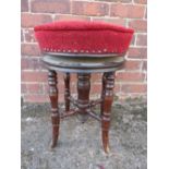 A VICTORIAN MAHOGANY CIRCULAR REVOLVING PIANO STOOL