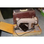 A CASED VINTAGE ELECTRIC SINGER SEWING MACHINE