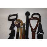 A COLLECTION OF MOSTLY MODERN WALKING STICKS TO INCLUDE A CARVED TRIBAL STYLE EXAMPLE TOGETHER