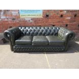 A GREEN LEATHER THREE SEATER CHESTERFIELD SETTEE
