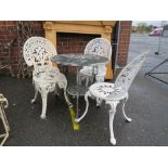 A CAST ALUMINIUM CIRCULAR TABLE WITH THREE ASSORTED CHAIRS A/F