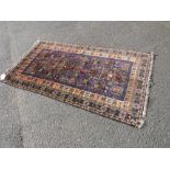 AN EASTERN WOOLLEN RUG WITH MAINLY BLUE GROUND 192 X 105 CM