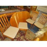 A RETRO TEAK EXTENDING DINING TABLE AND FOUR CHAIRS