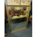 A LARGE MODERN GILT FRAMED RECTANGULAR WALL MIRROR 112 X 87 CM