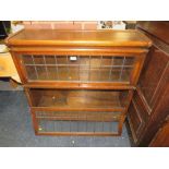 A SMALL VINTAGE TWO STAGE GLOBE WERNICKE STYLE OAK AND LEADED BOOKCASE H-89 W-87 CM