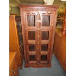 A COLONIAL HARDWOOD TWO DOOR CUPBOARD WITH METAL GRILLS H-153 -76 CM