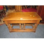 A SOLID OAK NEST OF TABLES W CM WITH A CIRCULAR WALNUT OCCASIONAL TABLE (2)