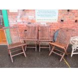 A SET OF FOUR WOODEN FOLDING GARDEN CHAIRS