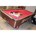 A POOL TABLE WITH BALLS AND CUES