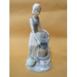 A NAO FIGURE OF A LADY BESIDE A FOUNTAIN