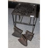 THREE VINTAGE CAST METAL IRONS ON A CAST METAL TRIVET STAND, TRIVET STAND HEIGHT - 33CM