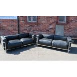 A PAIR OF MODERN BLACK AND CHROMED TWO SEATER SETTEES