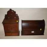 A VINTAGE CARVED OAK CANDLE BOX TOGETHER WITH A MAHOGANY TAMBOUR FRONTED LETTER RACK