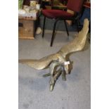 A LARGE BRASS FIGURE OF AN EAGLE ON A BRANCH HEIGHT - 53CM