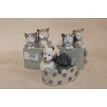 THREE NAO FIGURES OF CATS AND DOGS IN BASKETS