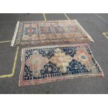 TWO EASTERN WOOLLEN RUGS - BOTH WITH DAMAGES, LARGEST 215 X 139 CM