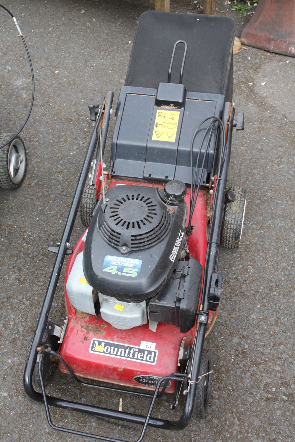 A MOUNTFIELD PETROL LAWNMOWER WITH GRASS BOX