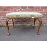 A REPRODUCTION CHIPPENDALE STYLE UPHOLSTERED STOOL ON BALL AND CLAW FEET H-55 W-90 CM
