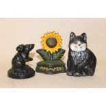 THREE SMALL CAST METAL DOOR STOPS IN THE FORM OF A CAT, MOUSE AND SUN FLOWER